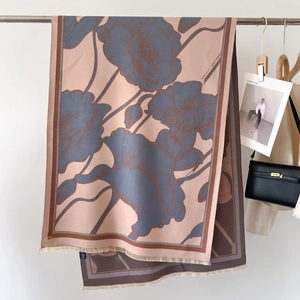 Elegant thick winter scarf in lotus pink with blue floral patterns and tassels
