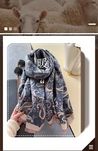 Close-up of blue cashmere-like paisley scarf with delicate tassels and floral patterns
