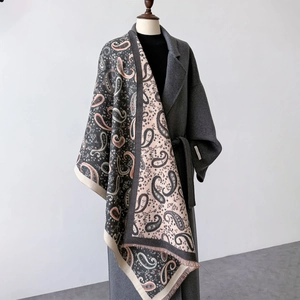 Detail of paisley pattern and fringe on a reversible oversized cashmere-feel pashmina shawl