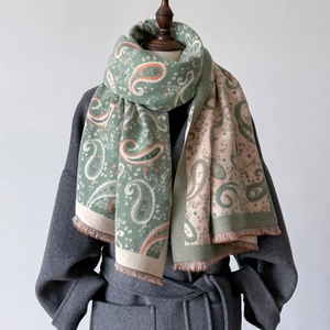 Close-up of paisley pattern on warm cashmere-feel pashmina shawl with fringe detail