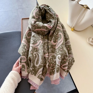 Detail of olive green paisley shawl with pink floral jacquard and soft tassel fringe