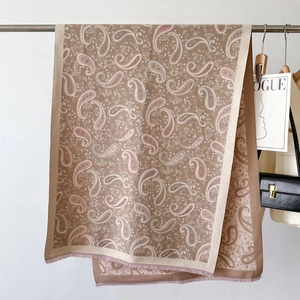 Detailed view of paisley patterns and soft fringe on this warm cashmere-like shawl
