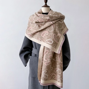 Detail of soft paisley pattern scarf with pink fringe on grey wool coat styling