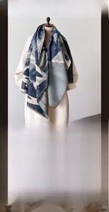 Detail of blue and grey mountain landscape jacquard pattern on a warm winter scarf