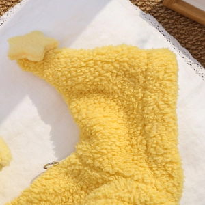 Dettaglio del gilet giallo in pile per animali con stella e morbida trama di peluche
