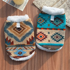 Close-up of ethnic fleece pet vests with Aztec patterns and metal D-rings for leashes