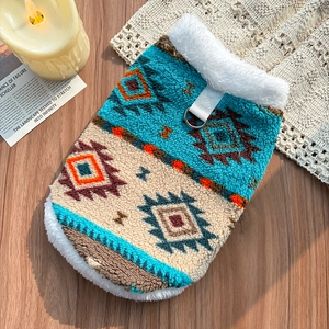Detail of Nordic pattern pet fleece vest with plush trim and metal D-ring for leash