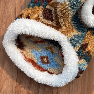 Close-up of Fair Isle pet sweater featuring warm fleece lining and bohemian pattern fabric