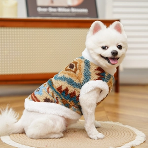 Close-up of fluffy ethnic pet vest with geometric jacquard pattern on a white dog