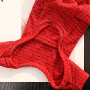 Close-up of red and black striped pet sweater featuring soft faux rabbit fur texture