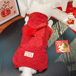 Detail of red striped dog hoodie with plush pom-pom and D-ring for New Year festive wear