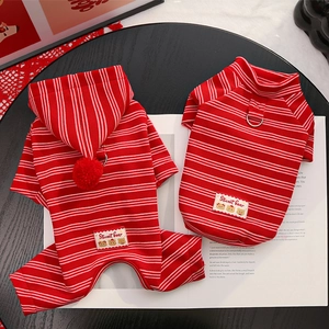 Close-up of red and white striped pet sweaters with metal D-rings and cute bear patches