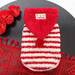 Striped red dog hoodie with fluffy bear hat on a festive wooden background