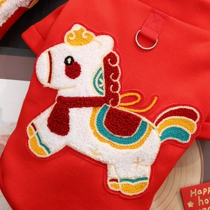 Detail of red pet apparel featuring textured horse embroidery and metal D-ring buckle