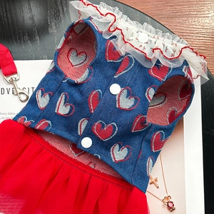 Detail of denim dog dress featuring heart prints, red lace collar and tulle skirt