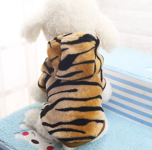 Detailed close-up of tiger-striped flannel pet hoodie on small dog showing soft texture
