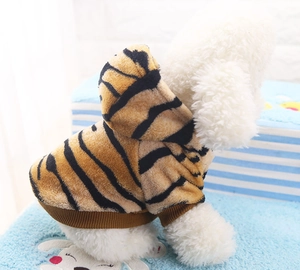 Detailed back view of tiger striped flannel pet hoodie on a white dog over blue blanket