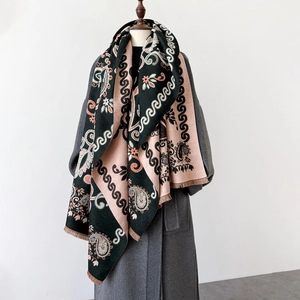 Détail du motif jacquard paisley et des franges douces sur l'écharpe châle noire