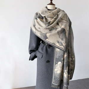Elegant large shawl scarf with lotus pattern and tassels draped over a coat