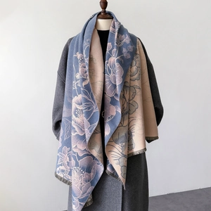 Detail of grey-blue and beige floral knit scarf with delicate frayed edge trim