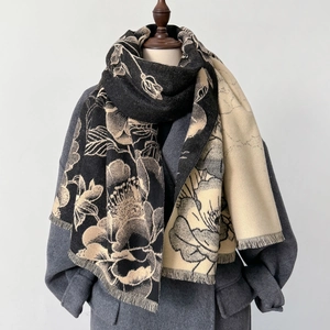 Detail of floral jacquard scarf showing thick knit texture and fine fringe tassels
