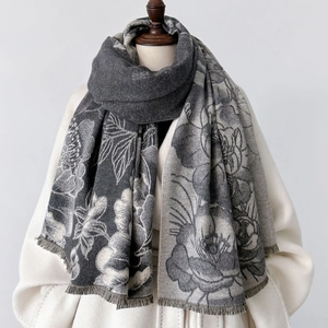 Detail of elegant oversized scarf with floral pattern and soft fringe edges for winter