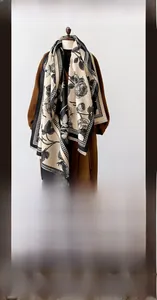 Detail of beige winter shawl with black rose and houndstooth pattern over brown coat