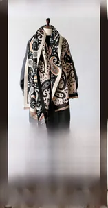 Detail of paisley pashmina scarf in soft faux cashmere with tassel hem for women