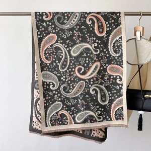 Detailed view of paisley pattern on warm winter pashmina shawl with short fringe trim