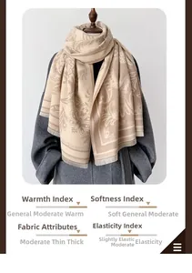 Detail of vintage paisley floral pattern and soft fringe on the beige cashmere scarf