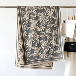 Detail view of vintage paisley jacquard scarf with premium fringed edges in grey and beige