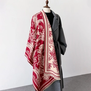 Elegant paisley print shawl in deep red and beige with decorative fringed edges