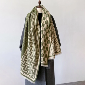 Detail of dark green and cream geometric plaid shawl with elegant tassel fringe
