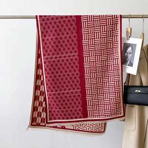 Elegant red and beige geometric jacquard scarf with fringe styled on a classic beige coat