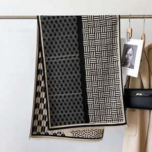 Detail showing high-end black and beige jacquard scarf with geometric knit texture