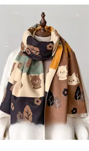 Detail of faux cashmere scarf with cat motifs and dense fringe on the edges