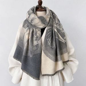 Classic cashmere-like scarf with floral patterns and fringe on a wool coat