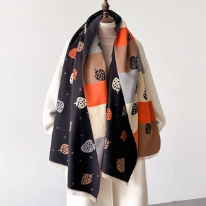 Detailed view of strawberry print patchwork scarf with soft fringe and thick texture