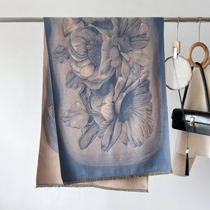 Detail of floral cashmere-feel shawl with elegant blue and khaki weave and fringe