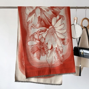 Detail of soft cashmere feel scarf with large floral print and tassel edges