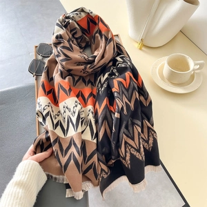 Close-up of zigzag patterned pashmina scarf with fringe detail and lifestyle accessories
