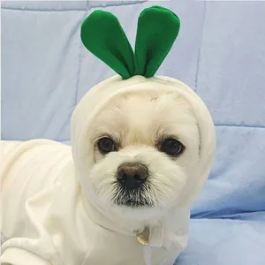 Detail of white fleece pet hoodie with green leaf decor on a Maltese dog