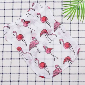 Detail of breathable mesh pet vest with pink flamingo prints on blue checkered background