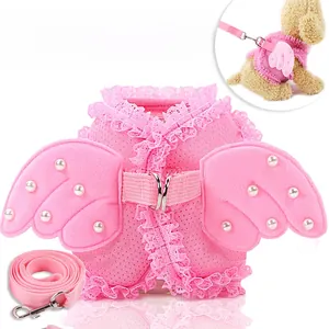 Detail of pink mesh dog harness with lace edges, pearl angel wings and matching leash