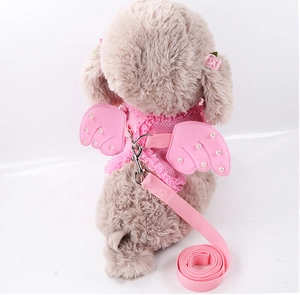 Detailed view of pink lace pet harness with pearl-embellished angel wings on a dog model