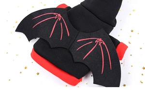 Detail of pet Halloween costume showing black cotton fabric with red trim and bat wings