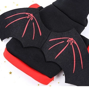 Festive pet bat costume with black wings and red bone print on a soft hooded outfit