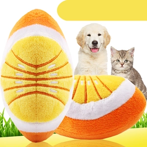 Detail of orange slice plush pet squeaky toy featuring embroidery and soft fabric texture