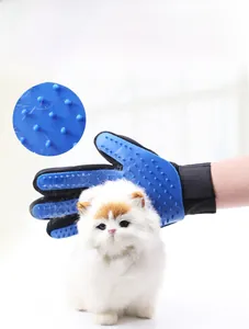 Close-up of blue silicone pet grooming glove showing bionic grooming tips on a cat