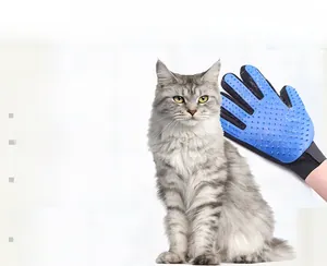 Detail showing blue silicone grooming bristles removing grey cat hair from the glove